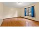 Empty bedroom with hardwood flooring, natural light, and neutral colored walls at 252 N Raceway Rd, Indianapolis, IN 46234