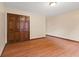 Bedroom features hardwood floors and a closet with folding doors at 252 N Raceway Rd, Indianapolis, IN 46234