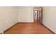 Spacious bedroom with hardwood floors, open door, and electrical outlets at 252 N Raceway Rd, Indianapolis, IN 46234