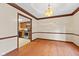 Dining room adjacent to kitchen with stainless steel appliances and wood cabinets at 252 N Raceway Rd, Indianapolis, IN 46234
