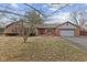 Charming brick home featuring an attached two car garage and a welcoming red front door at 252 N Raceway Rd, Indianapolis, IN 46234