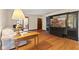 Spacious living room with hardwood floors, large windows, and a built in entertainment center at 252 N Raceway Rd, Indianapolis, IN 46234