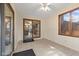 Sunroom with tile flooring, windows, and sliding glass door leading to the backyard at 252 N Raceway Rd, Indianapolis, IN 46234