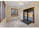 Bright sunroom with tile flooring, large windows, and access to the backyard at 252 N Raceway Rd, Indianapolis, IN 46234