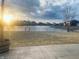 Beautiful backyard view of a serene pond, homes in the distance, and a sunrise over a large grassy area at 254 Halldale Dr, Whiteland, IN 46184