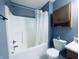 Bathroom featuring a shower-tub combination with a wooden cabinet and standard toilet at 254 Halldale Dr, Whiteland, IN 46184