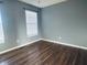 Empty bedroom featuring hardwood floors, gray walls and natural light from windows at 254 Halldale Dr, Whiteland, IN 46184