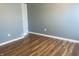 Empty bedroom featuring hardwood floors, gray walls and natural light from windows at 254 Halldale Dr, Whiteland, IN 46184