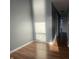An empty bedroom features wood flooring, gray walls, white trim and lots of sunshine at 254 Halldale Dr, Whiteland, IN 46184
