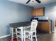 Cozy dining area with a wooden table and stools, complemented by wood cabinets and a ceiling fan at 254 Halldale Dr, Whiteland, IN 46184