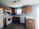 Bright kitchen featuring light wood cabinets, white appliances, and a peninsula counter at 254 Halldale Dr, Whiteland, IN 46184