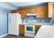 Functional kitchen features white appliances, ample cabinetry, and a clean design at 254 Halldale Dr, Whiteland, IN 46184