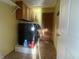 Laundry room with black appliances, wood cabinets, and tile floors at 254 Halldale Dr, Whiteland, IN 46184