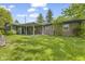 The backyard features a covered patio, brick accents, and lush green grass at 2818 S Irwin St, Indianapolis, IN 46203