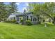 The backyard showcases a well-maintained lawn, mature trees, and a bird bath feature at 2818 S Irwin St, Indianapolis, IN 46203