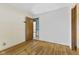 An empty bedroom displays natural wood floors, bright white walls, and a connecting doorway at 2818 S Irwin St, Indianapolis, IN 46203