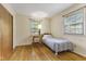 Cozy bedroom featuring wood floors, natural light from two windows, and a comfortable bed at 2818 S Irwin St, Indianapolis, IN 46203