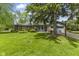 Single-story brick home with green lawn and mature tree near attached two-car garage at 2818 S Irwin St, Indianapolis, IN 46203