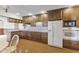 Classic kitchen design with wooden cabinets, white appliances, and a neutral countertop space at 2818 S Irwin St, Indianapolis, IN 46203