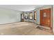 Spacious living room featuring neutral carpet, large windows with curtains, and a classic grandfather clock at 2818 S Irwin St, Indianapolis, IN 46203