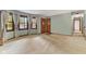 Large living room with neutral carpet, an entrance, and bay windows with curtains for natural light at 2818 S Irwin St, Indianapolis, IN 46203
