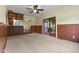 Living room featuring wood paneling, carpet, and sliding glass doors at 2818 S Irwin St, Indianapolis, IN 46203