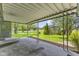 Covered patio with concrete flooring offers a view of a large, grassy backyard at 2818 S Irwin St, Indianapolis, IN 46203