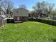 Spacious backyard with lush green grass, enclosed by a wooden fence, offering plenty of room for outdoor activities at 3060 S Lyons Ave, Indianapolis, IN 46241