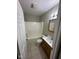 Bathroom features a tub and shower combination, single sink vanity, tile floor, and a mirrored cabinet at 3060 S Lyons Ave, Indianapolis, IN 46241