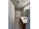 Clean bathroom with tile flooring, white tub/shower, vanity with a single sink, and a vanity mirror at 3060 S Lyons Ave, Indianapolis, IN 46241