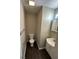 Cozy bathroom with a toilet, single sink vanity, and sleek dark wood floors at 3060 S Lyons Ave, Indianapolis, IN 46241