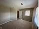 Empty bedroom with carpeted floor, neutral walls, one closet, and natural light streaming through the windows at 3060 S Lyons Ave, Indianapolis, IN 46241