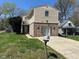 Two-story home with brick and siding, a well-manicured lawn, and a paved driveway leading up to the house at 3060 S Lyons Ave, Indianapolis, IN 46241