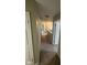 Hallway with neutral walls, carpet, and white doors leading to bedrooms and other rooms at 3060 S Lyons Ave, Indianapolis, IN 46241