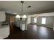 Open-concept kitchen featuring white cabinets, dark wood floors, and ample counter space at 3060 S Lyons Ave, Indianapolis, IN 46241