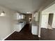 Well-lit kitchen featuring white cabinets and dark wood floors at 3060 S Lyons Ave, Indianapolis, IN 46241