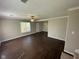 Bright and airy living room with modern dark wood flooring, neutral walls, and a ceiling fan at 3060 S Lyons Ave, Indianapolis, IN 46241