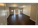 Spacious living room featuring dark wood floors, neutral walls, and sliding glass doors at 3060 S Lyons Ave, Indianapolis, IN 46241