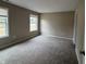 Cozy bedroom featuring plush carpeting, neutral paint, and bright natural light at 320 Lakewood Ct, Avon, IN 46123
