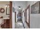 Well-lit hallway featuring wood-look tile flooring, charming decor, and access to a bathroom at 3762 N Foxcliff E Dr, Martinsville, IN 46151