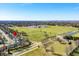 A vibrant neighborhood sits next to an expansive green park in this sunny aerial view at 3932 Villa Dr, Columbus, IN 47203