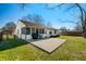Spacious backyard with a concrete patio, lawn, and a screened-in porch at 3932 Villa Dr, Columbus, IN 47203