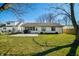 Large backyard featuring a well-maintained lawn, patio, and view of the home's exterior at 3932 Villa Dr, Columbus, IN 47203
