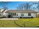 Expansive backyard with a concrete patio, grassy lawn, and exterior of the home at 3932 Villa Dr, Columbus, IN 47203