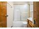 Bathroom featuring a tub with sliding glass doors and wood-finished vanity at 3932 Villa Dr, Columbus, IN 47203