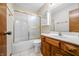 Cozy bathroom featuring a tub with shower and vanity with wood finish at 3932 Villa Dr, Columbus, IN 47203