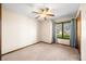 Comfortable carpeted bedroom with ample natural light and a ceiling fan for added comfort at 3932 Villa Dr, Columbus, IN 47203