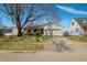 Inviting home featuring a lush front lawn and a long driveway at 3932 Villa Dr, Columbus, IN 47203