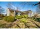 Home featuring mature landscaping, stone accents, and lush green lawn at 3932 Villa Dr, Columbus, IN 47203