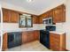 Modern kitchen showcasing sleek black appliances and warm oak cabinetry for a cozy, functional design at 3932 Villa Dr, Columbus, IN 47203